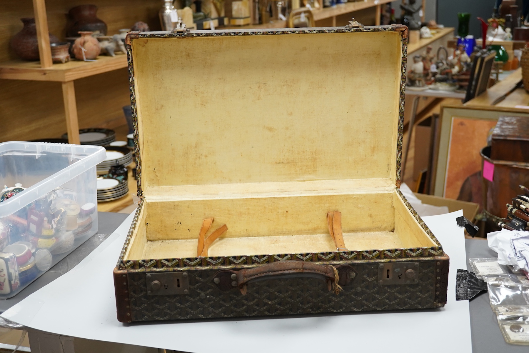 A vintage Malles Goyard suitcase with all over printed design, applied metal label to the exterior, height 13cm, width 49cm, depth 30cm
